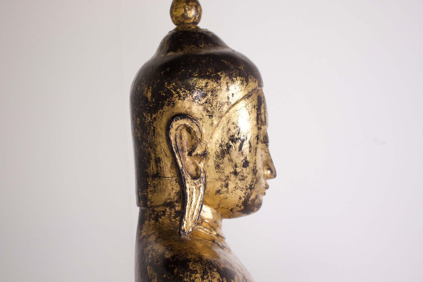 Visage de profil d'un Ancien grand bouddha debout du Myanmar en bois doré de la collection Claude de Marteau vu