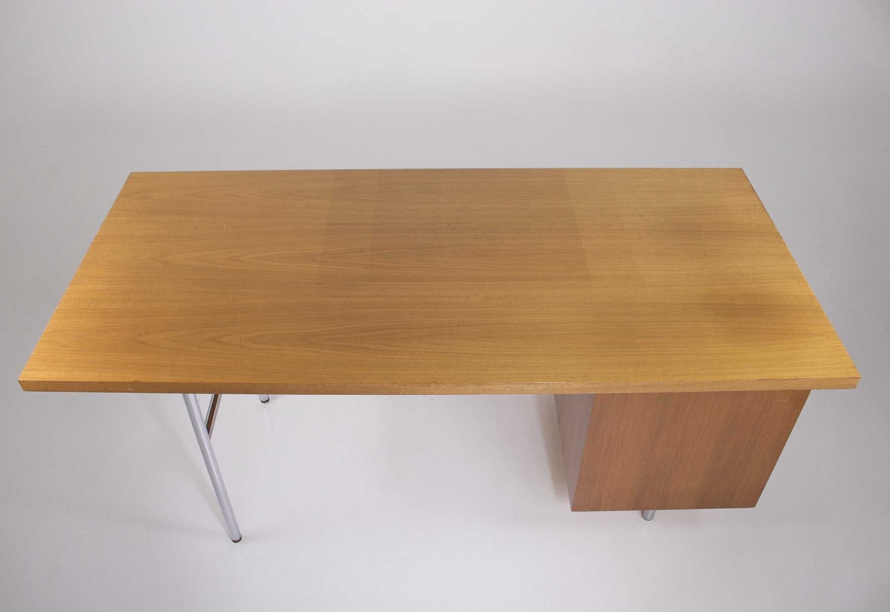 High-angle view of the desk, showing the condition of the top which has a discoloration mark.