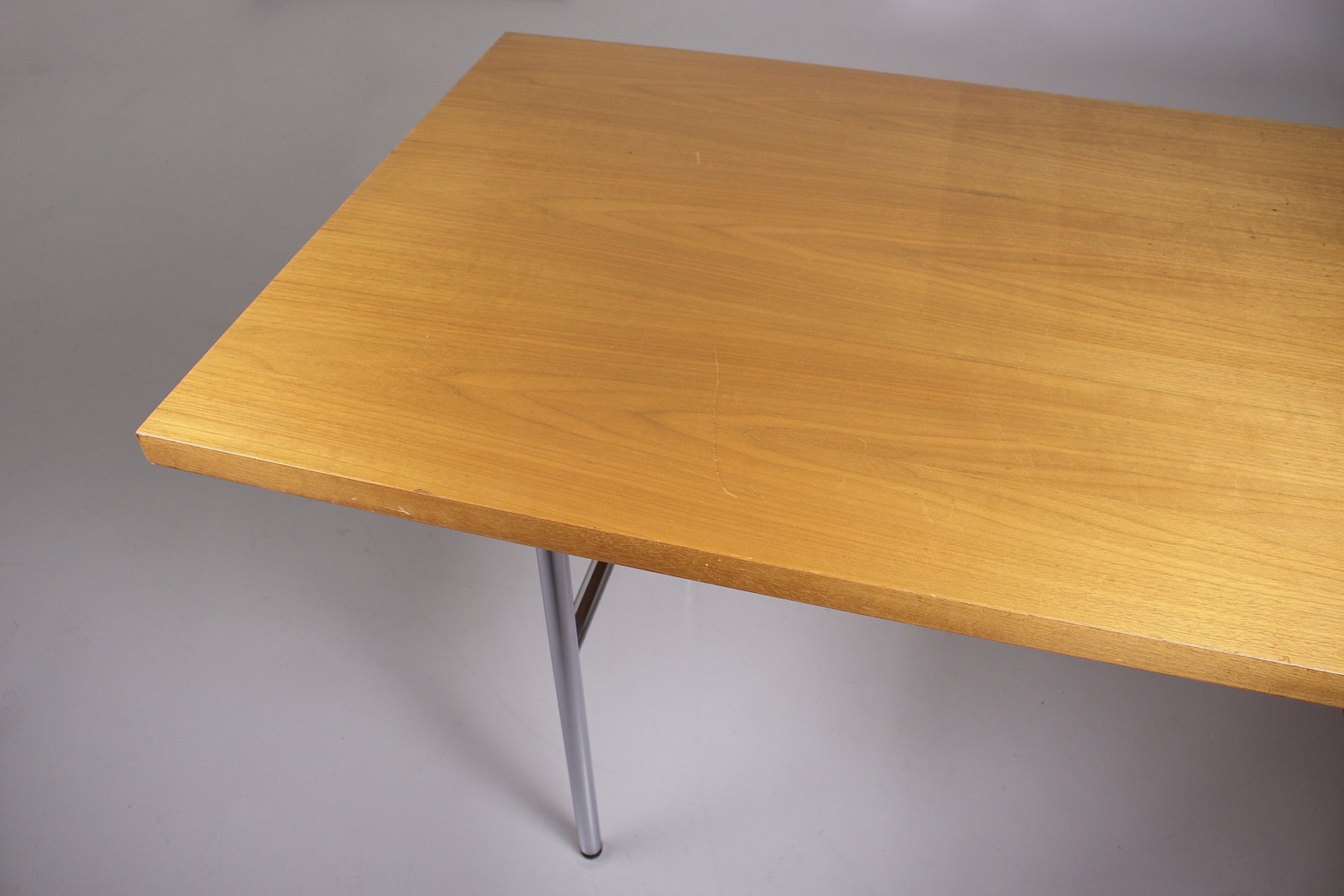 A small scratch on the top of the desk.