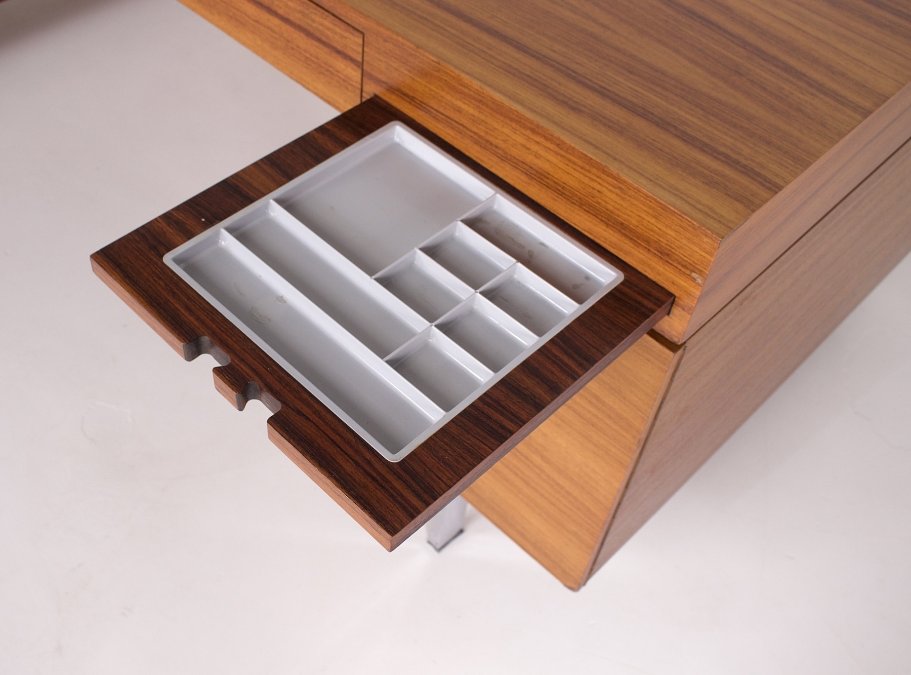 Catch-all drawer for pens, pencils and small office supplies.